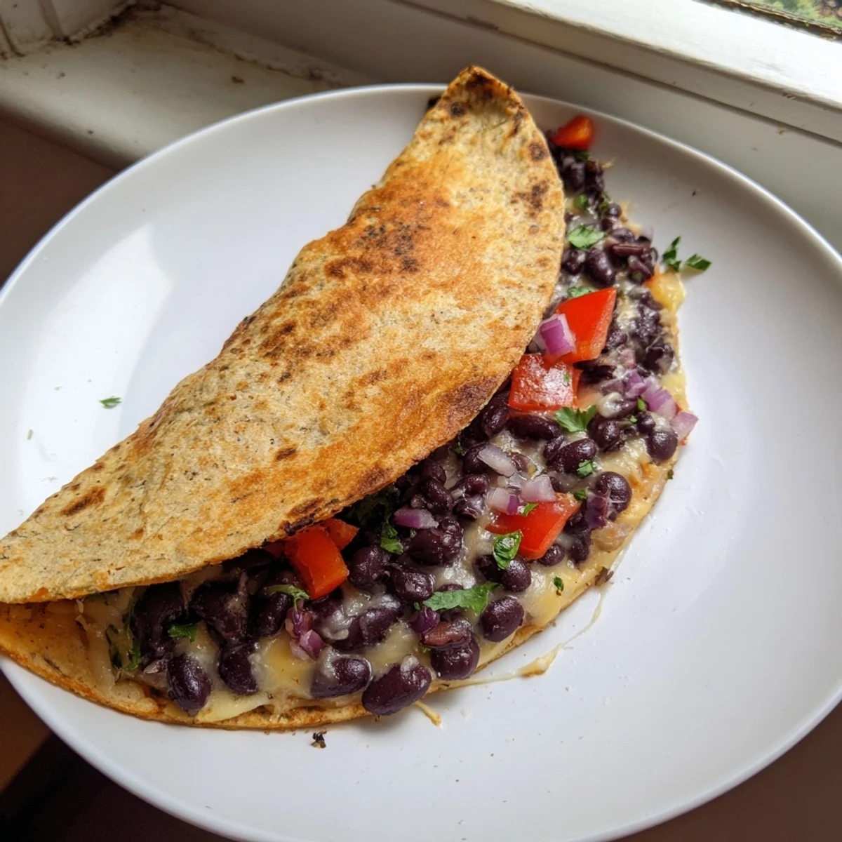 Golden-brown Vegetarian Quesadillas, filled with savory beans and cheese, ready to be cut and served.