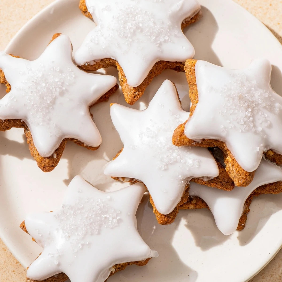 Close-up of freshly baked Cinnamon Stars, showcasing their delicate icing and cinnamon spice aroma.