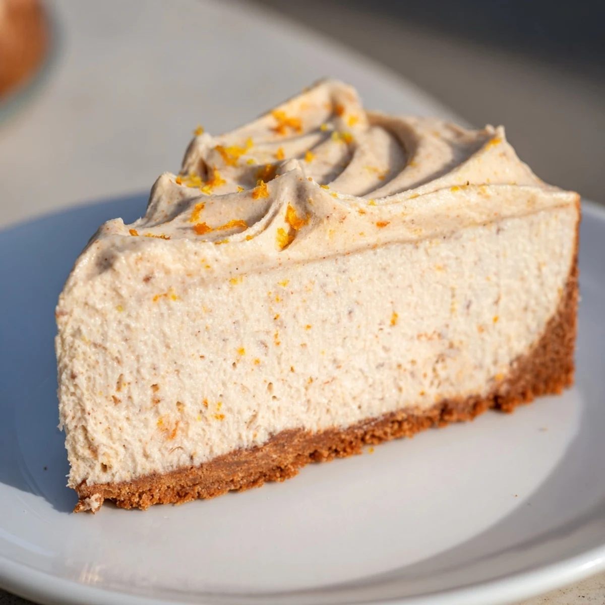 Rich, creamy Lebkuchen cheesecake with a swirl of cinnamon frosting, perfect for dessert.