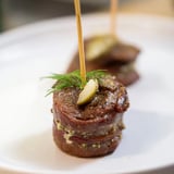 These bite-sized Mini Rouladen feature mustard, pickles, and bacon, ready to be served hot.