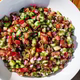 Colorful close-up of pickled cucumber pico de gallo featuring diced tomatoes and red onion, ideal for tacos.