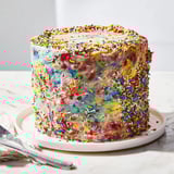 This homemade Chaotic Funfetti Cake with playful sprinkles looks delightful, ready to be enjoyed.