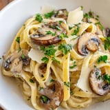 Close-up of Creamy Mushroom Alfredo pasta, golden mushrooms and Parmesan in a velvety sauce.