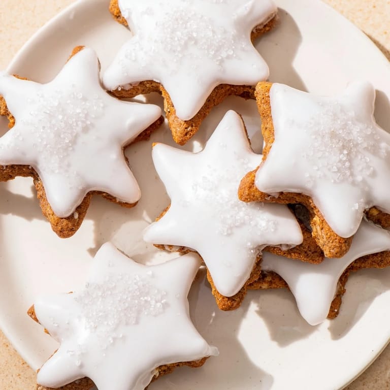 Close-up of freshly baked Cinnamon Stars, showcasing their delicate icing and cinnamon spice aroma.