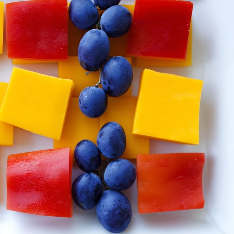 Fresh, colorful Bauhaus Block recipe, arranged geometrically with red pepper and cheese for guests.