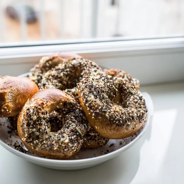 Close-up of a cucumber shaker with everything bagel seasoning coated cucumber slices, perfect for summer.